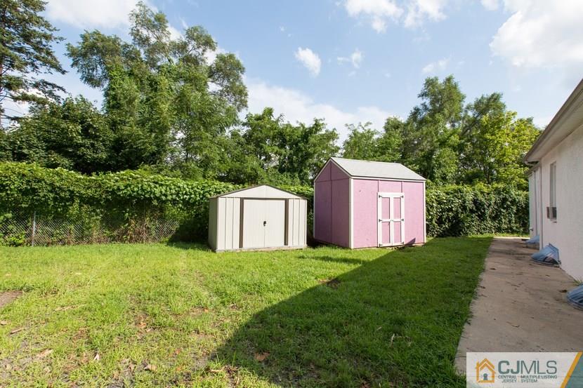 613 Old Post Road Edison, NJ 08817 - Photo 19 of 20 a view of a tiny house with a yard and large trees