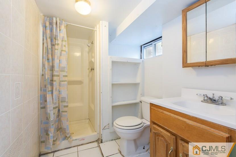 613 Old Post Road Edison, NJ 08817 - Photo 20 of 20 a bathroom with a shower a toilet and a sink