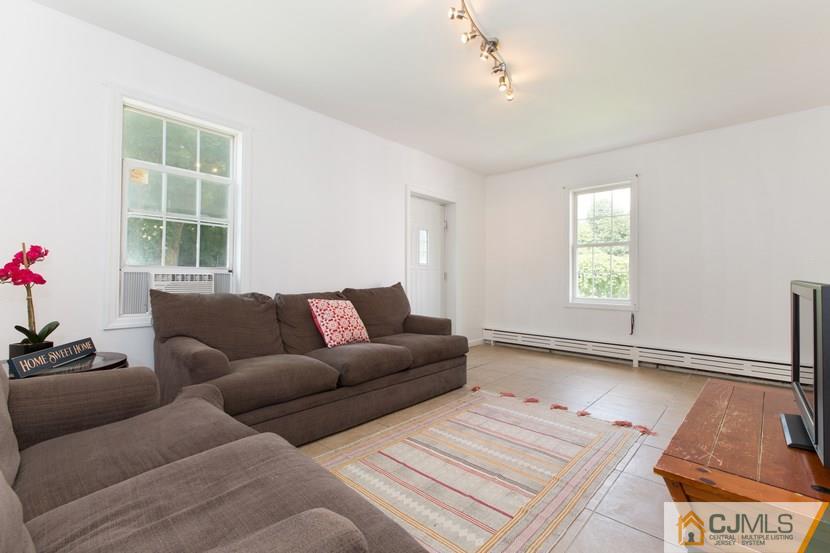 613 Old Post Road Edison, NJ 08817 - Photo 3 of 20 a living room with furniture and a window
