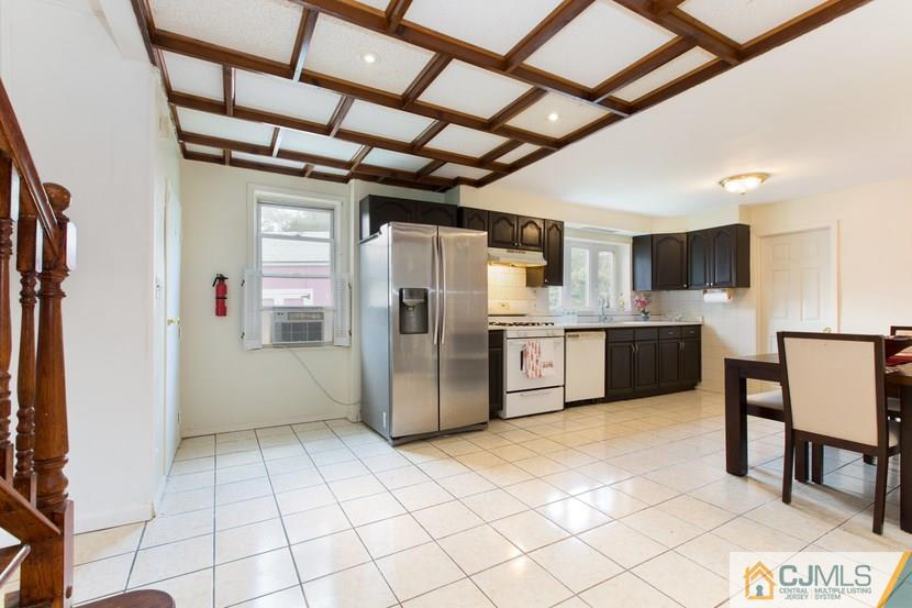 613 Old Post Road Edison, NJ 08817 - Photo 6 of 20 a kitchen with stainless steel appliances a refrigerator and a stove top oven