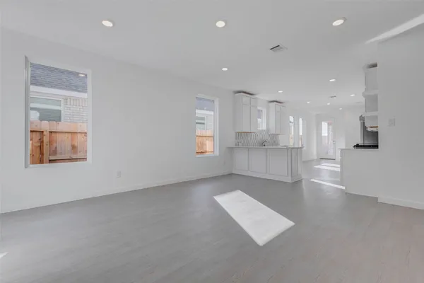 a kitchen with white cabinets and white appliances