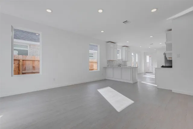 a kitchen with white cabinets and white appliances
