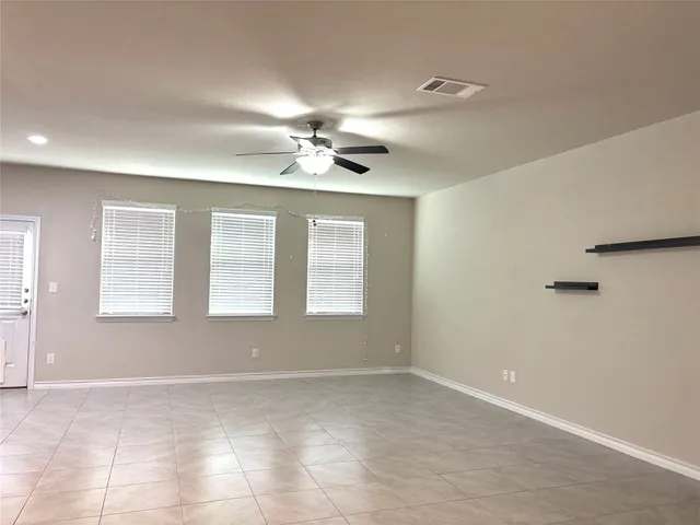 a view of an empty room and a bathroom
