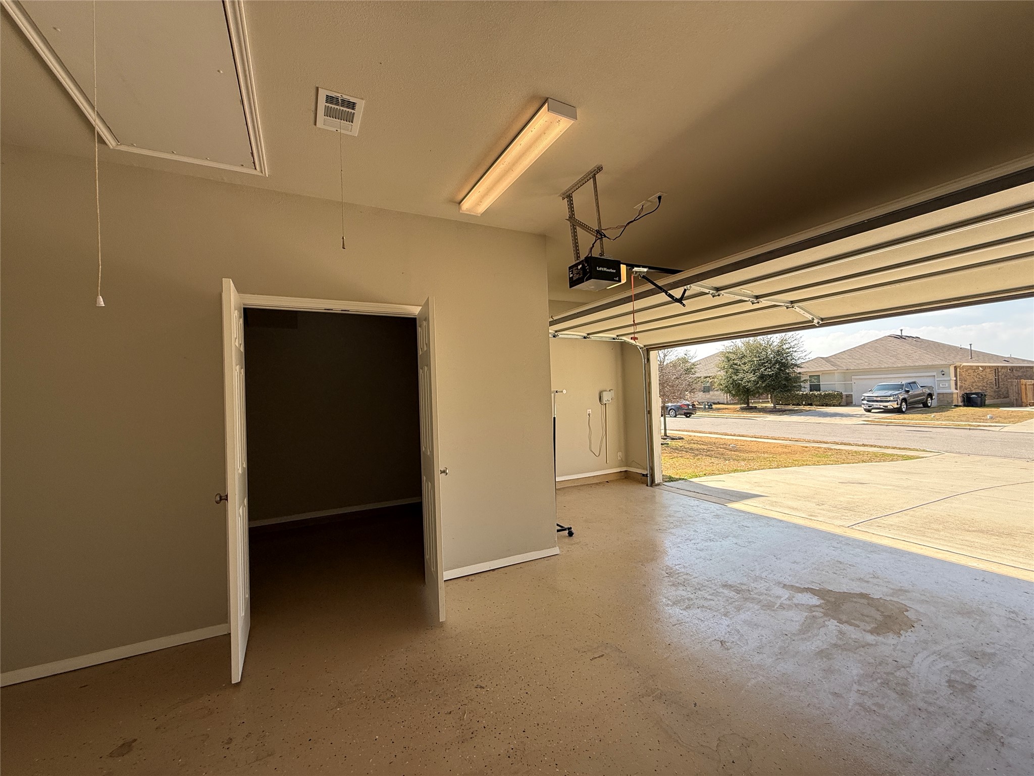5989 Malta Circle Round Rock, TX 78665 - Photo 34 of 36 Garage featuring baseboards and a garage door opener