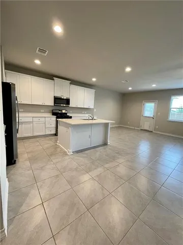 a bathroom with a granite countertop double sink and a mirror