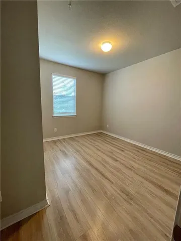 a view of a room with wooden floor
