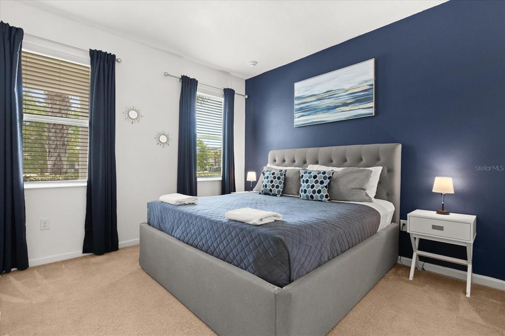 4565 Cabello Loop Kissimmee, FL 34746 - Photo 11 of 33 a bedroom with a bed and a chandelier