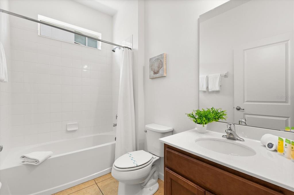 4565 Cabello Loop Kissimmee, FL 34746 - Photo 12 of 33 a bathroom with a sink toilet and shower