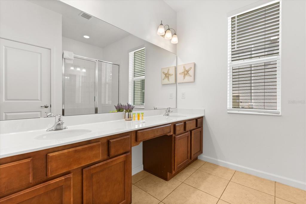4565 Cabello Loop Kissimmee, FL 34746 - Photo 15 of 33 a bathroom with a sink double vanity and a mirror