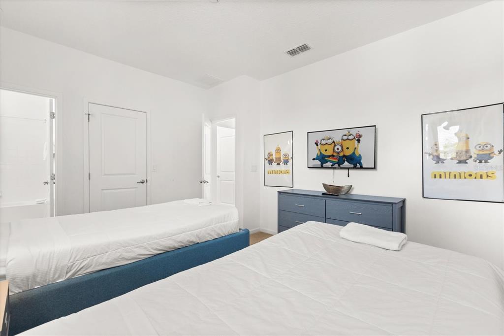 4565 Cabello Loop Kissimmee, FL 34746 - Photo 18 of 33 a bedroom with a bed and painting on the wall