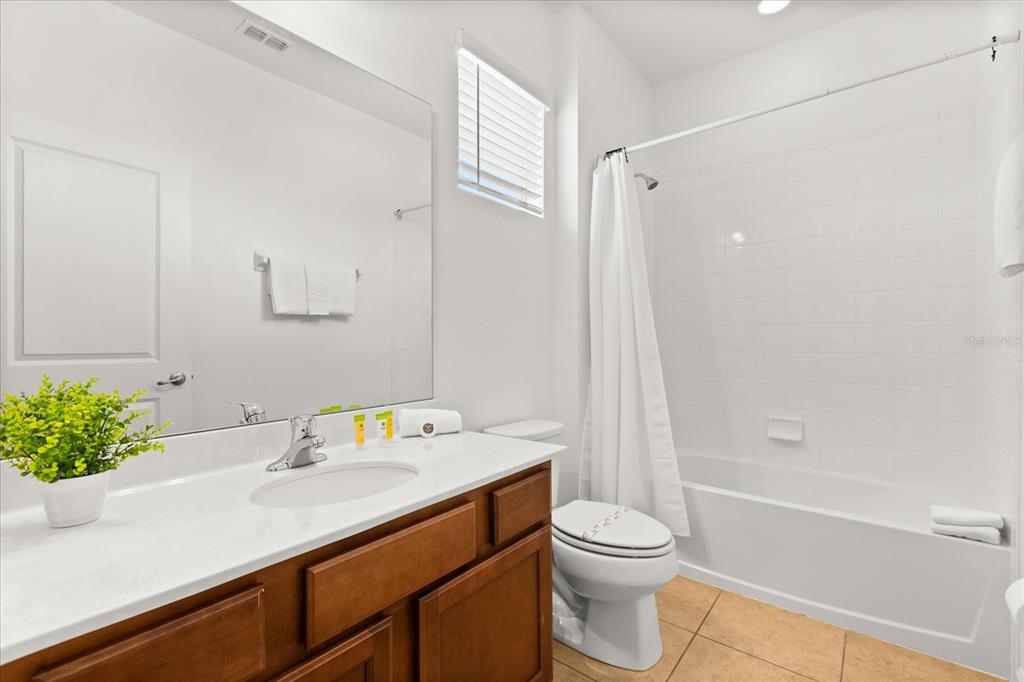 4565 Cabello Loop Kissimmee, FL 34746 - Photo 19 of 33 a bathroom with a sink a toilet and shower