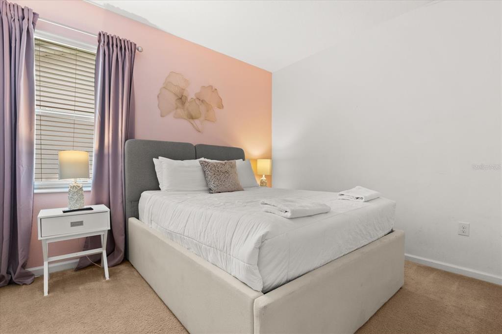 4565 Cabello Loop Kissimmee, FL 34746 - Photo 21 of 33 a bedroom with a bed and a painting on the wall