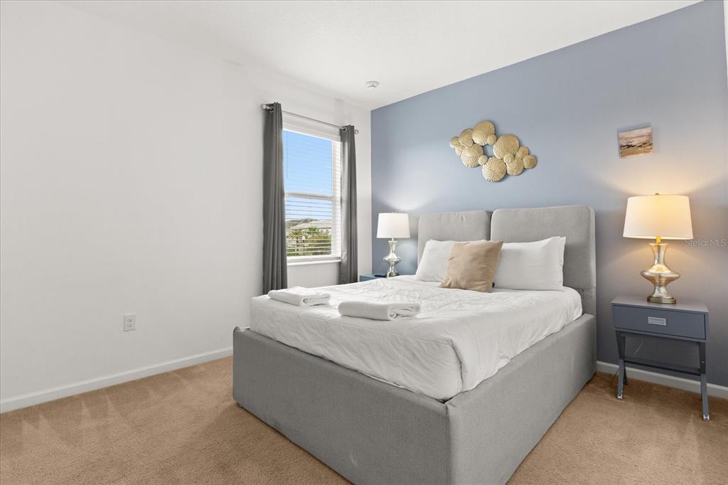 4565 Cabello Loop Kissimmee, FL 34746 - Photo 22 of 33 a bedroom with a bed and painting on the wall