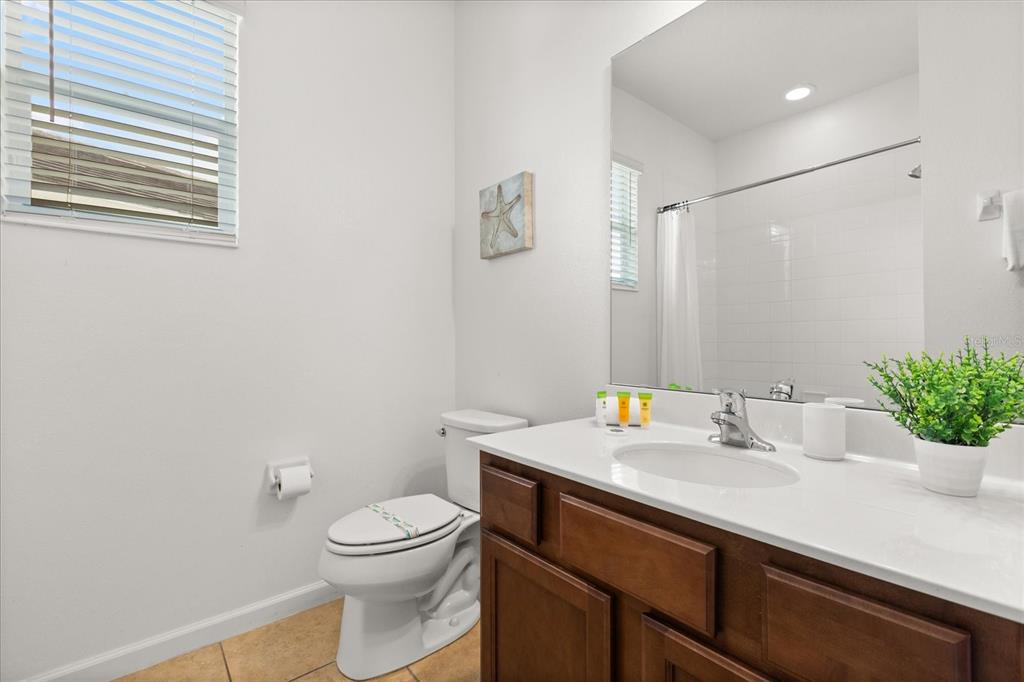 4565 Cabello Loop Kissimmee, FL 34746 - Photo 23 of 33 a bathroom with a sink a toilet and shower