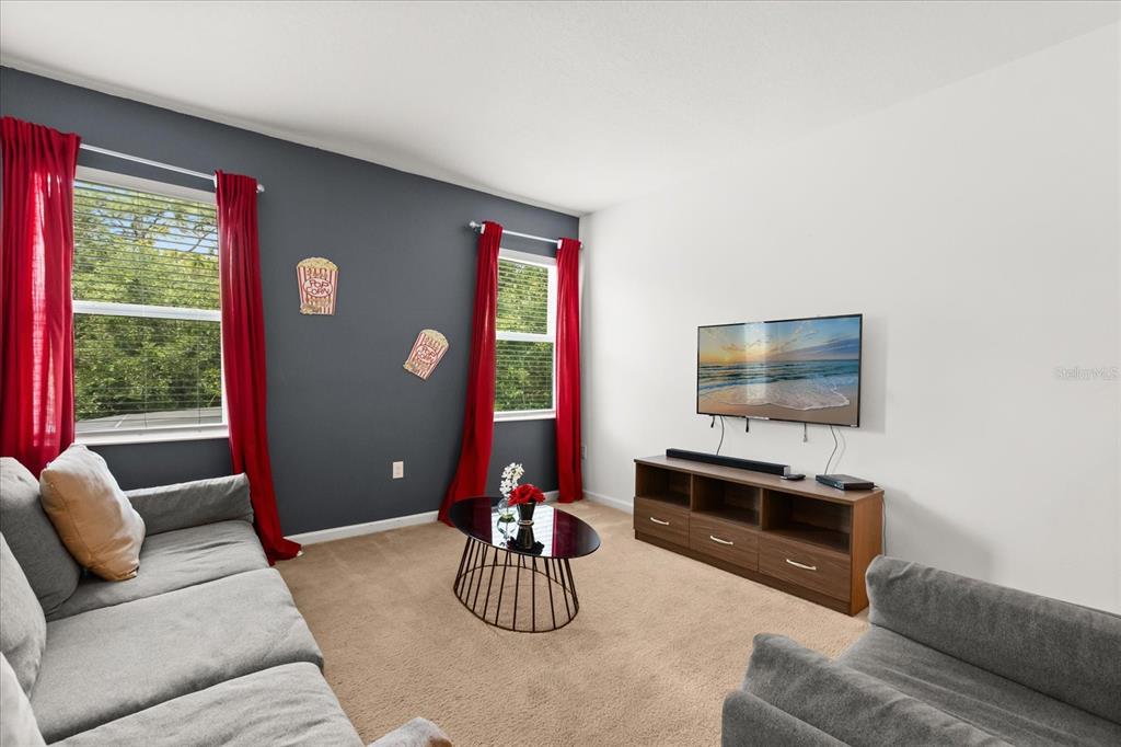 4565 Cabello Loop Kissimmee, FL 34746 - Photo 25 of 33 a living room with furniture and a flat screen tv