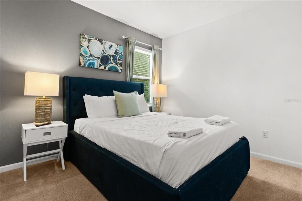 4565 Cabello Loop Kissimmee, FL 34746 - Photo 26 of 33 a bedroom with a bed and a window