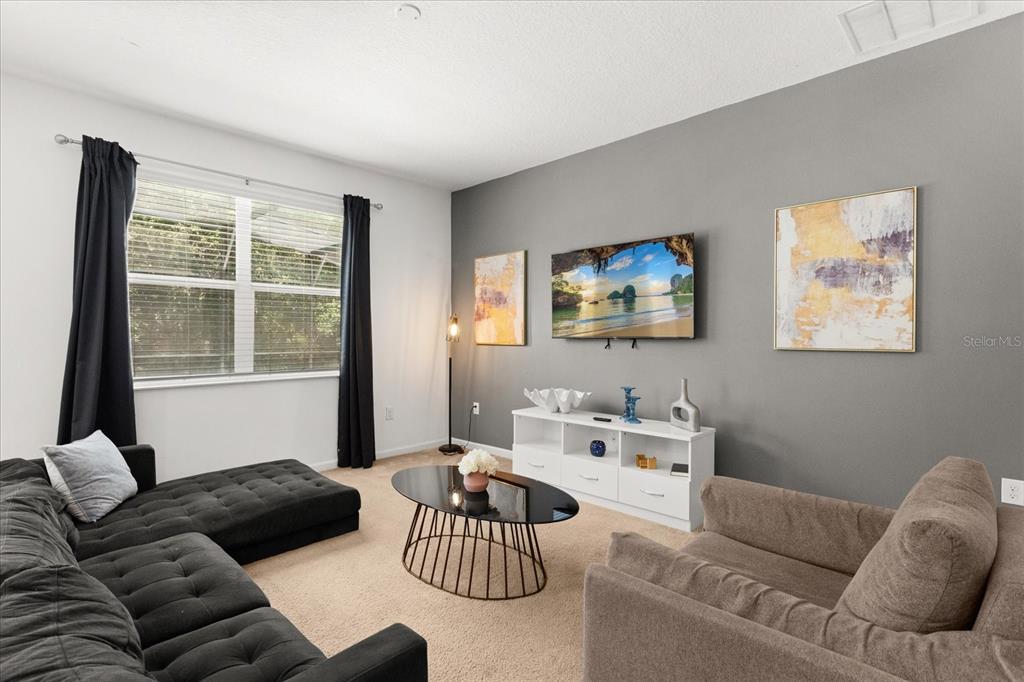 4565 Cabello Loop Kissimmee, FL 34746 - Photo 4 of 33 a living room with furniture and a flat screen tv