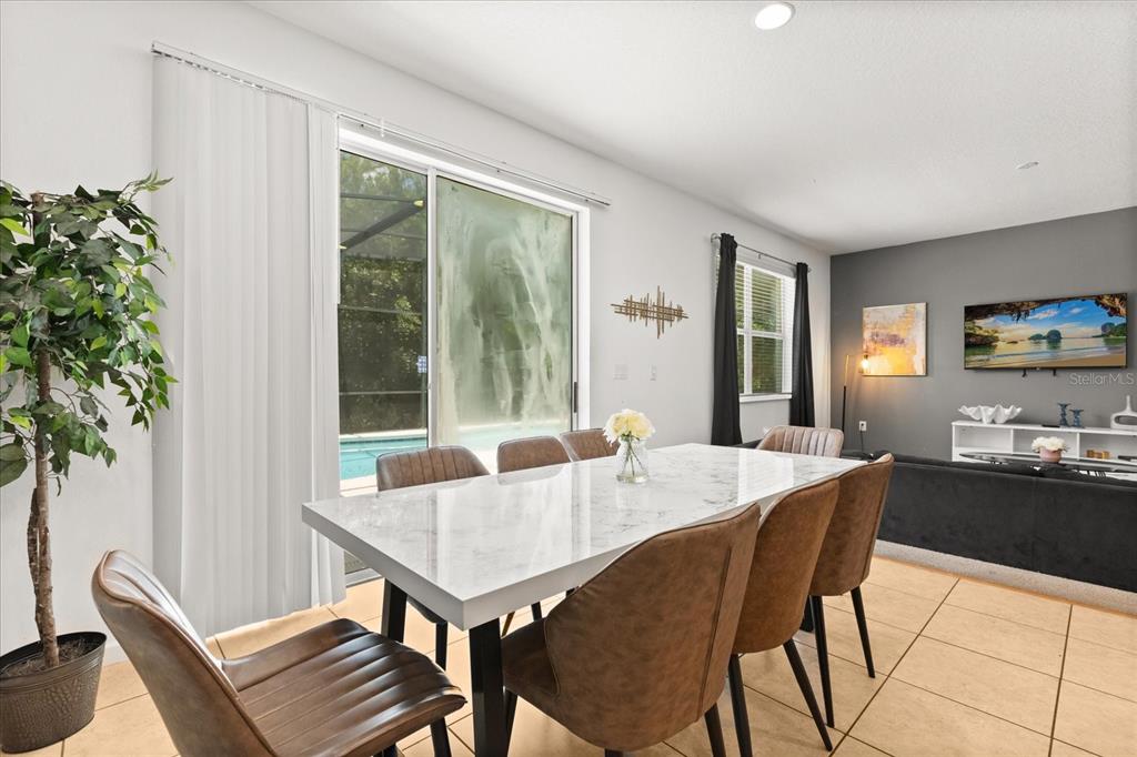 4565 Cabello Loop Kissimmee, FL 34746 - Photo 7 of 33 a view of a dining room with furniture window and wooden floor