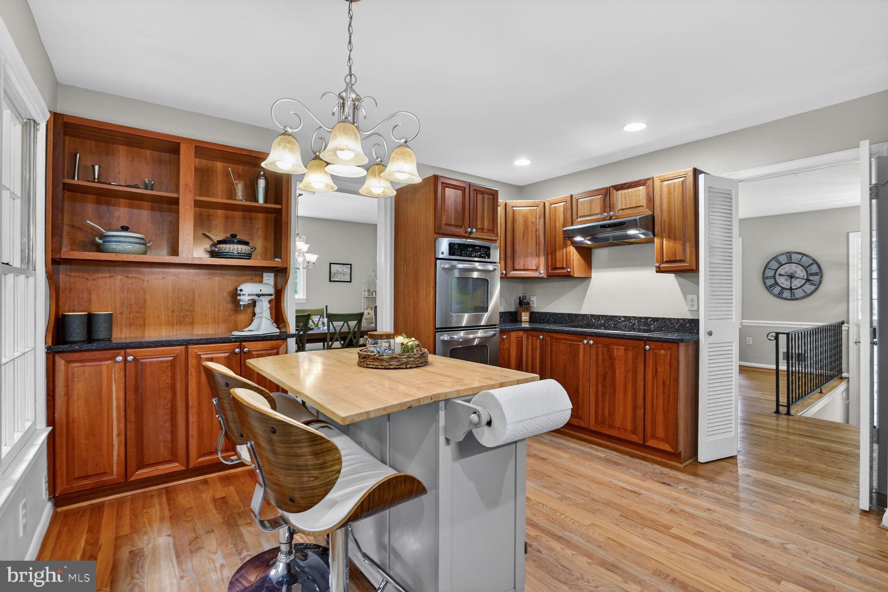 5024 Portsmouth Road Fairfax, VA 22032 - Photo 10 of 38 a kitchen with stainless steel appliances granite countertop a refrigerator a sink dishwasher a dining table and chairs with wooden floor