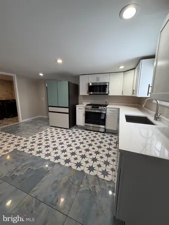 a kitchen with stainless steel appliances a sink and a stove