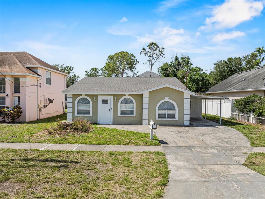 4408 West Prescott Street Tampa, FL 33616 - Photo 1 of 46 a front view of a house with a yard and garage