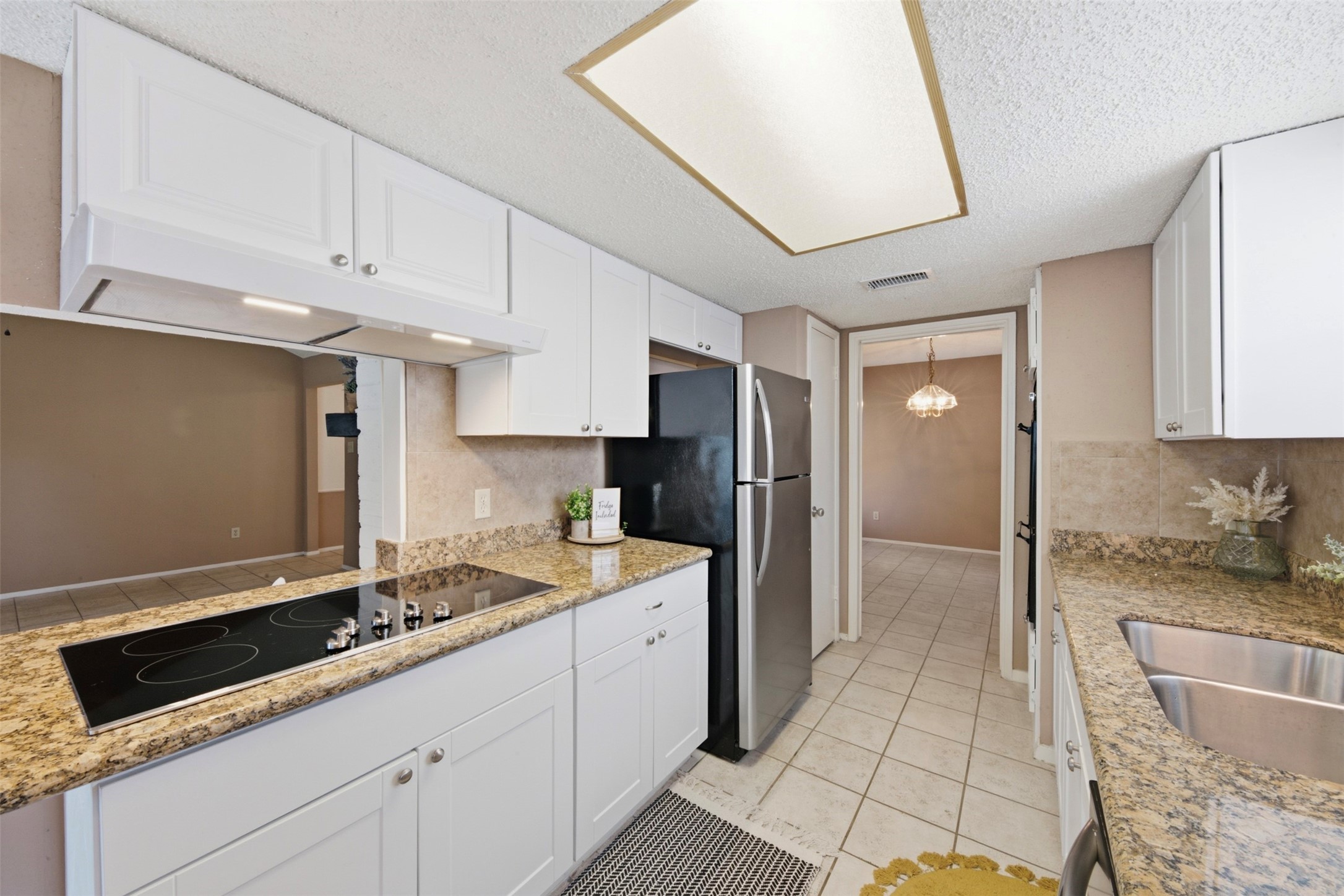 4019 Postwood Drive Spring, TX 77388 - Photo 12 of 50 a kitchen with granite countertop a sink stove and refrigerator