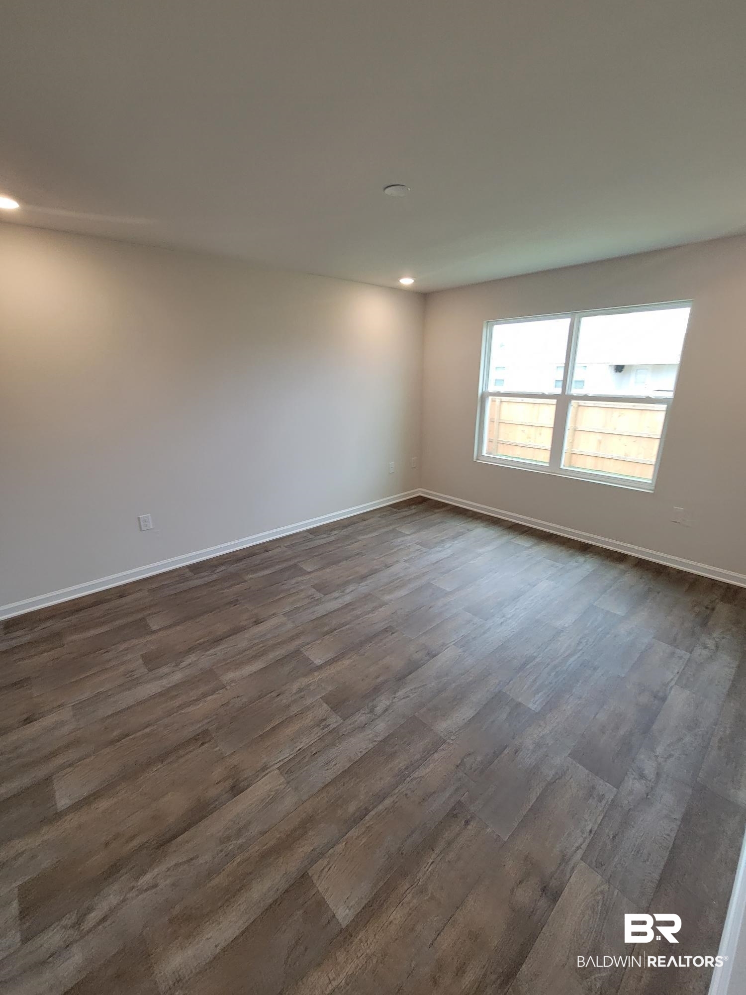 24625 Ponder Loop Loxley, AL 36551 - Photo 9 of 30 Unfurnished room with dark hardwood / wood-style flooring