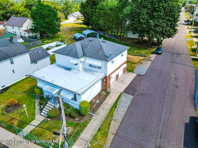 a aerial view of a house with a yard