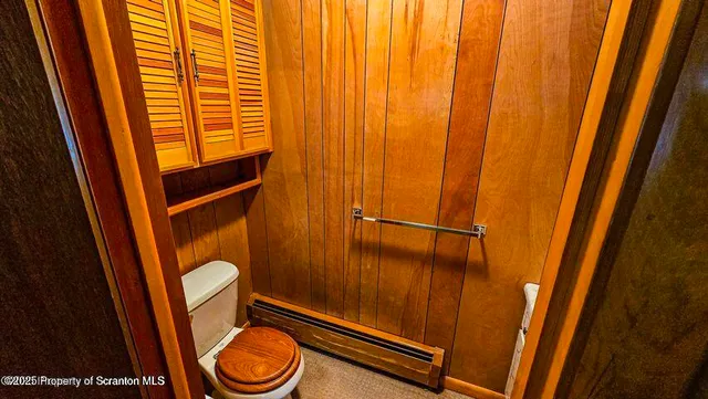 a bathroom with a toilet and a shower curtain