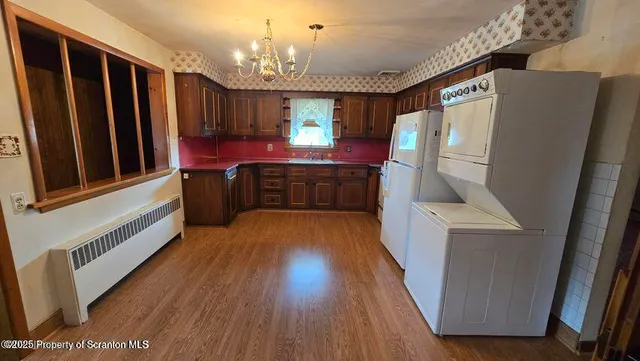 a kitchen with stainless steel appliances granite countertop a stove a sink dishwasher and a refrigerator