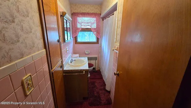 a bathroom with a shower and toilet