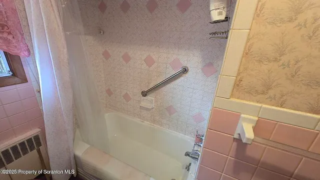 an empty room with a painting on the wall