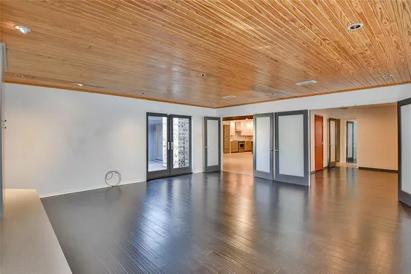 an empty room with wooden floor and closet