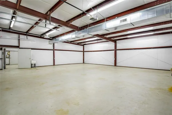a indoor patio with table and chairs and potted plants