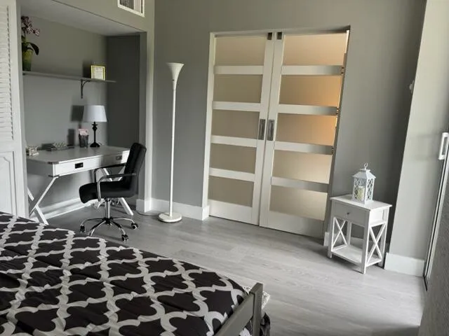 a view of living room with furniture and mirror