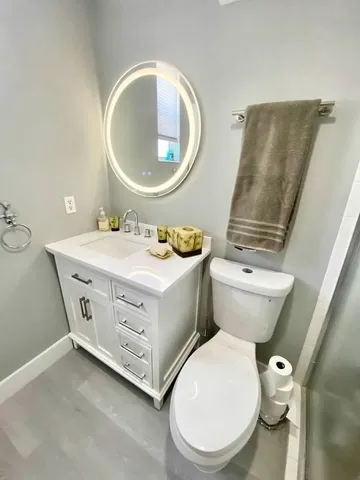 a bathroom with a toilet sink and mirror
