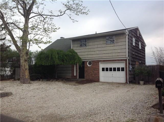 a view of a house with a yard and garage