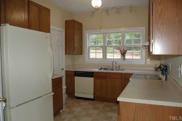 800 Rothshire Court Raleigh, NC 27615 - Photo 3 of 7 a kitchen with granite countertop a sink stove and refrigerator