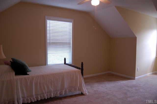 800 Rothshire Court Raleigh, NC 27615 - Photo 6 of 7 a bedroom with a bed and a window