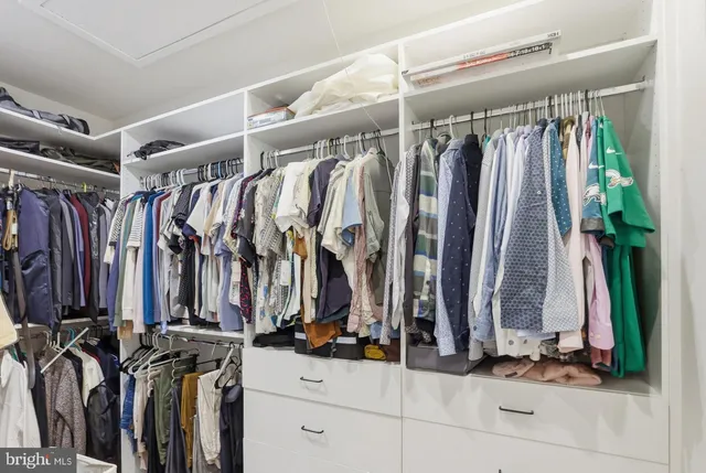 a bathroom with a double vanity sink a mirror and a bathtub
