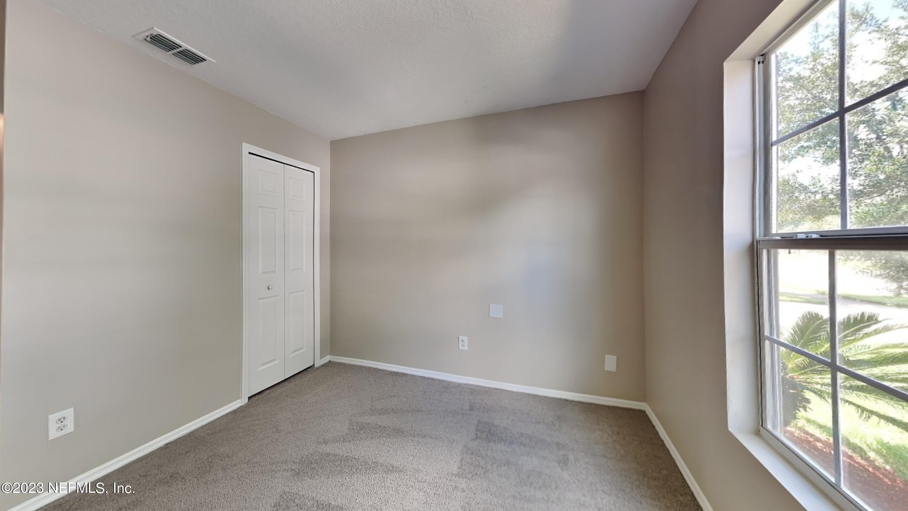 11907 Alexandra Drive Jacksonville, FL 32218 - Photo 11 of 14 an empty room with windows