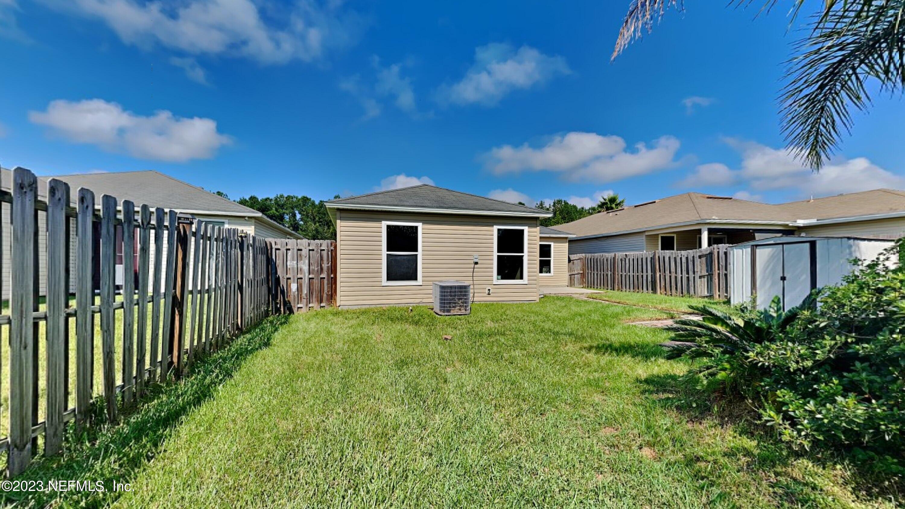 11907 Alexandra Drive Jacksonville, FL 32218 - Photo 13 of 14 a view of a house with backyard and garden