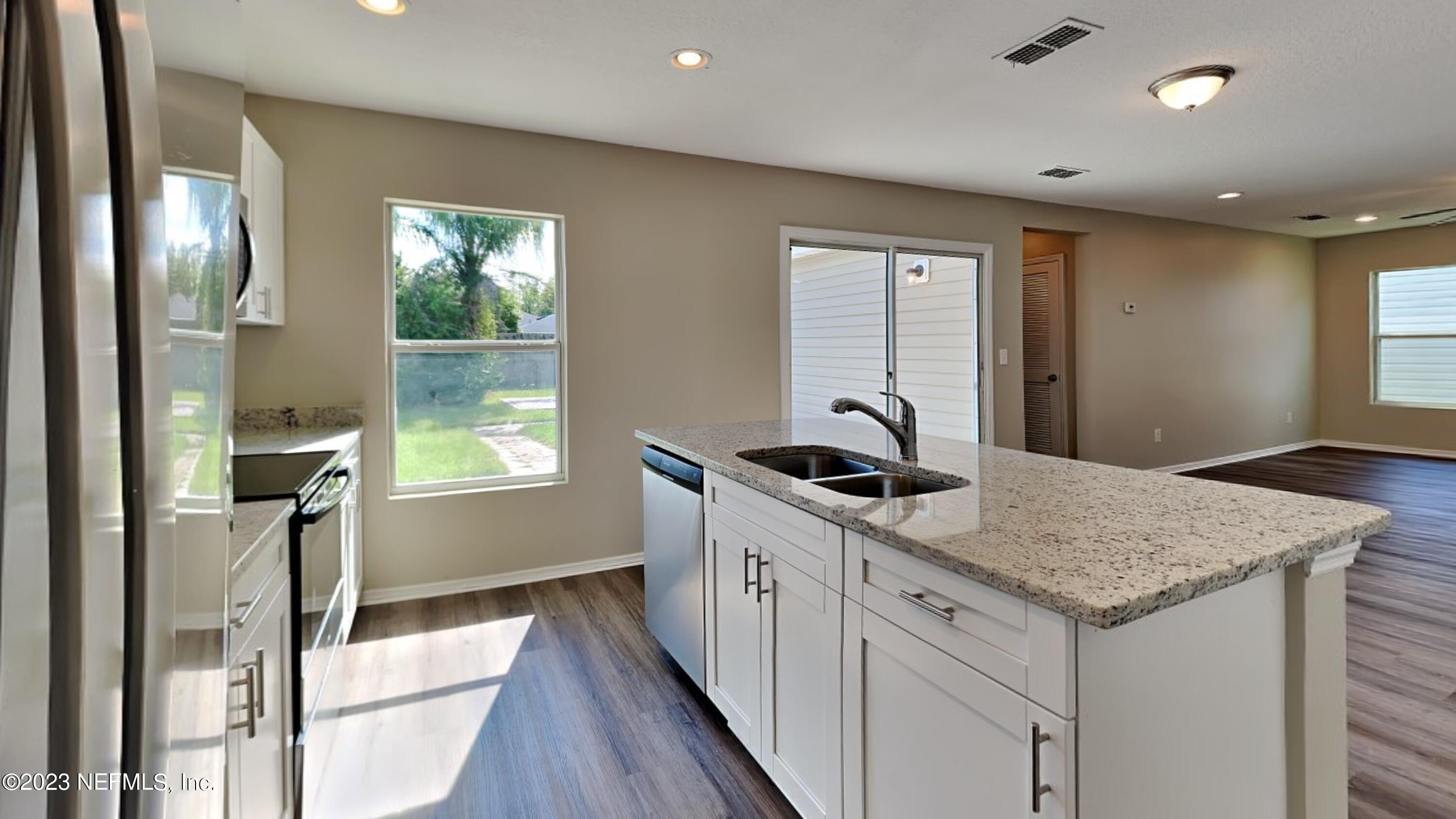 11907 Alexandra Drive Jacksonville, FL 32218 - Photo 6 of 14 a kitchen with a stove and a sink