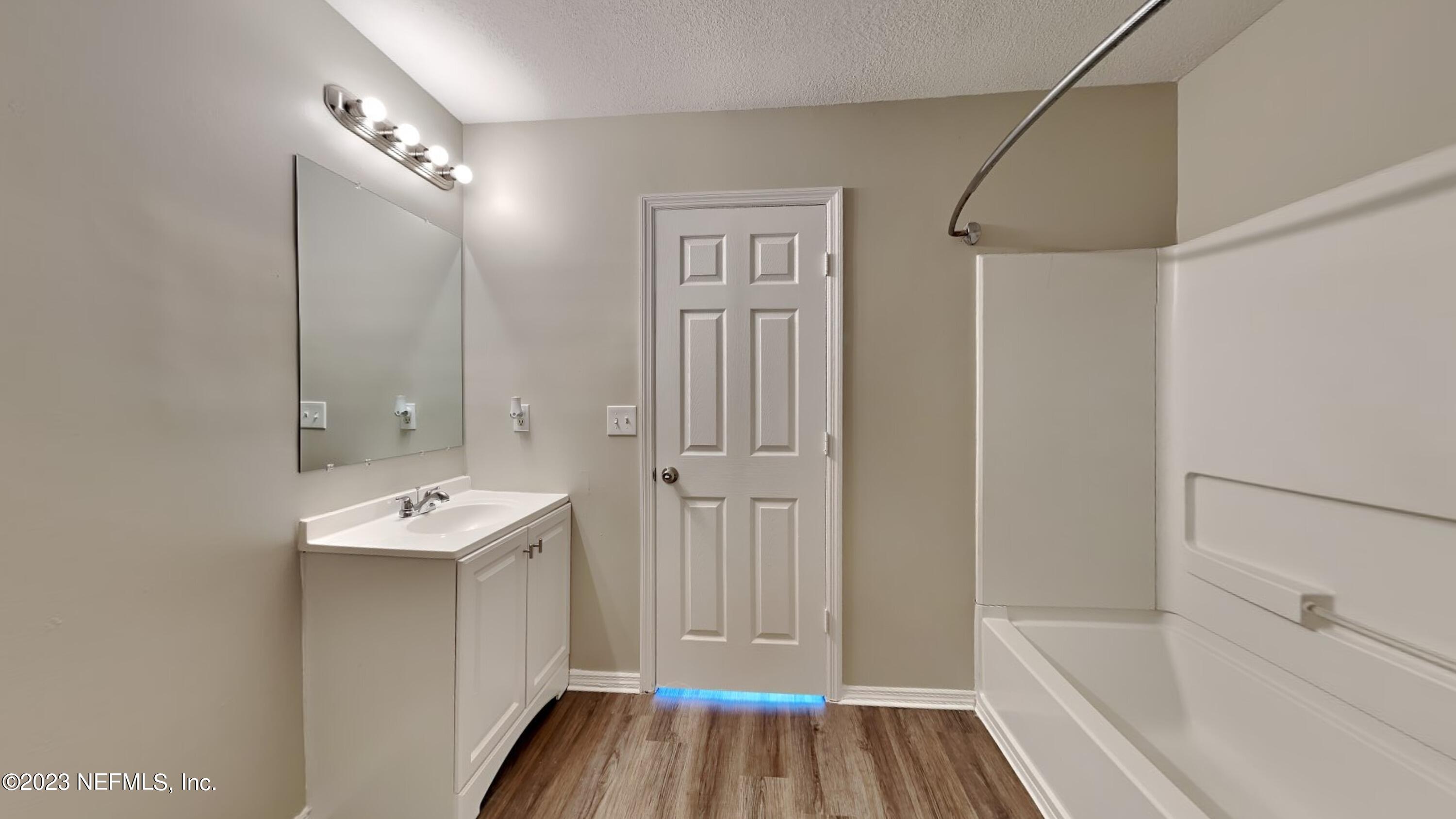 11907 Alexandra Drive Jacksonville, FL 32218 - Photo 8 of 14 a bathroom with a sink a mirror and a bathtub