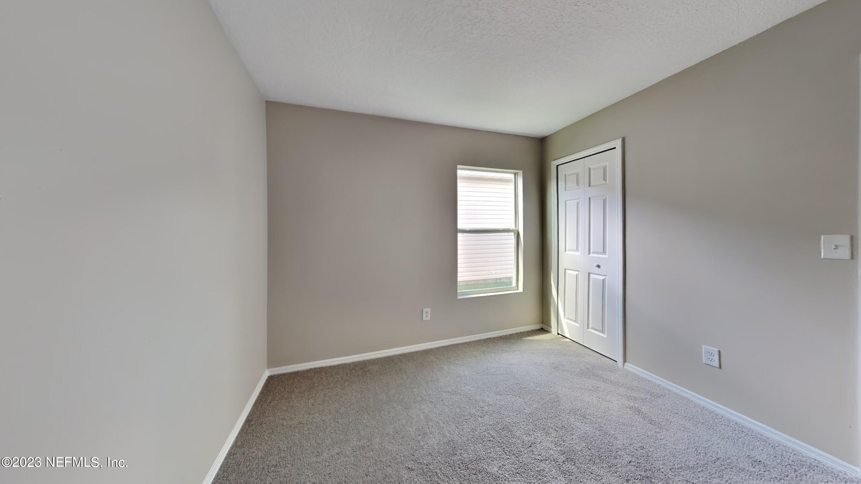 11907 Alexandra Drive Jacksonville, FL 32218 - Photo 9 of 14 a view of empty room with window