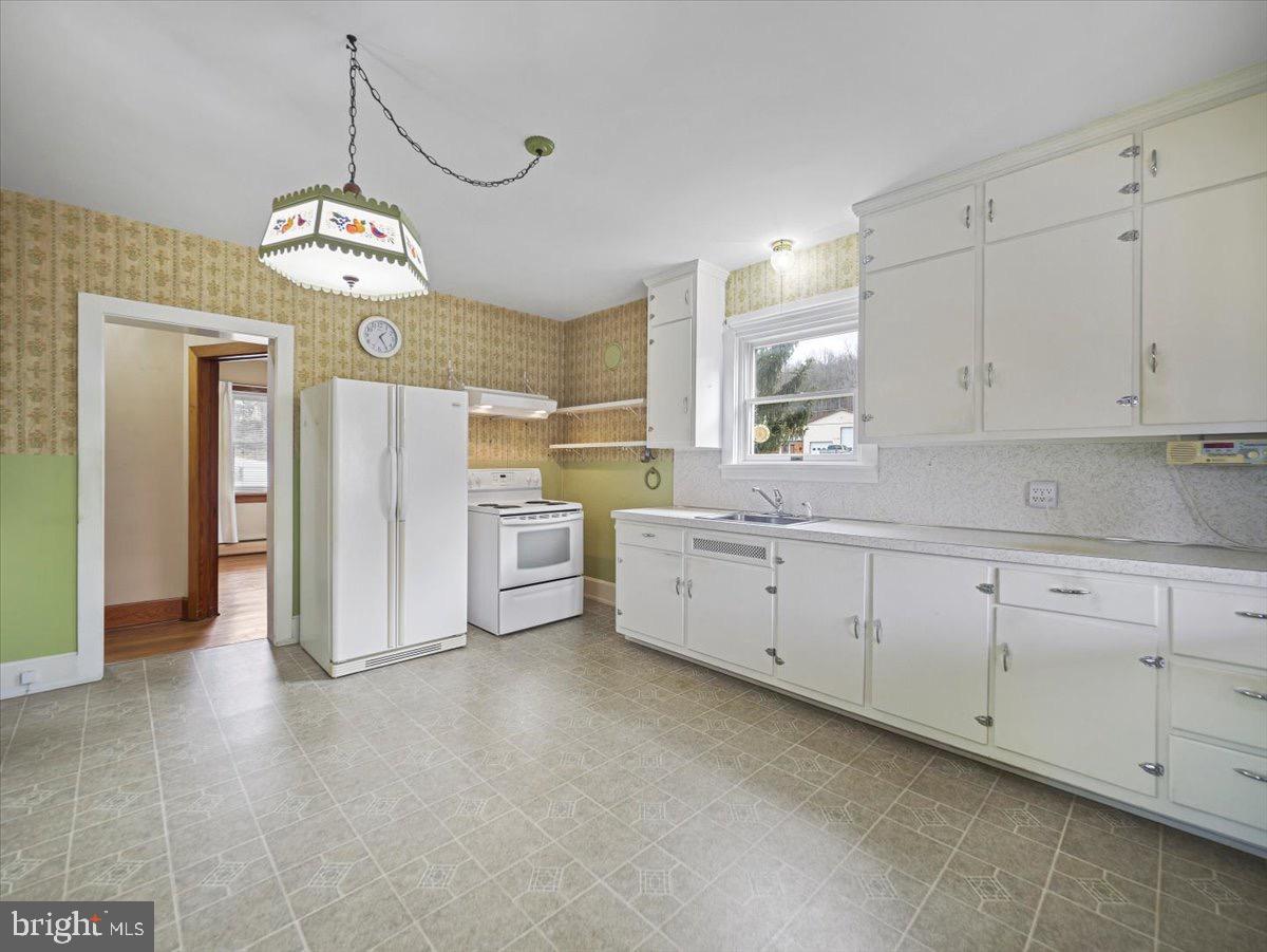 7220 Slabtown Road Waynesboro, PA 17268 - Photo 14 of 43 a open kitchen with cabinets a center island stainless steel appliances and a chandelier