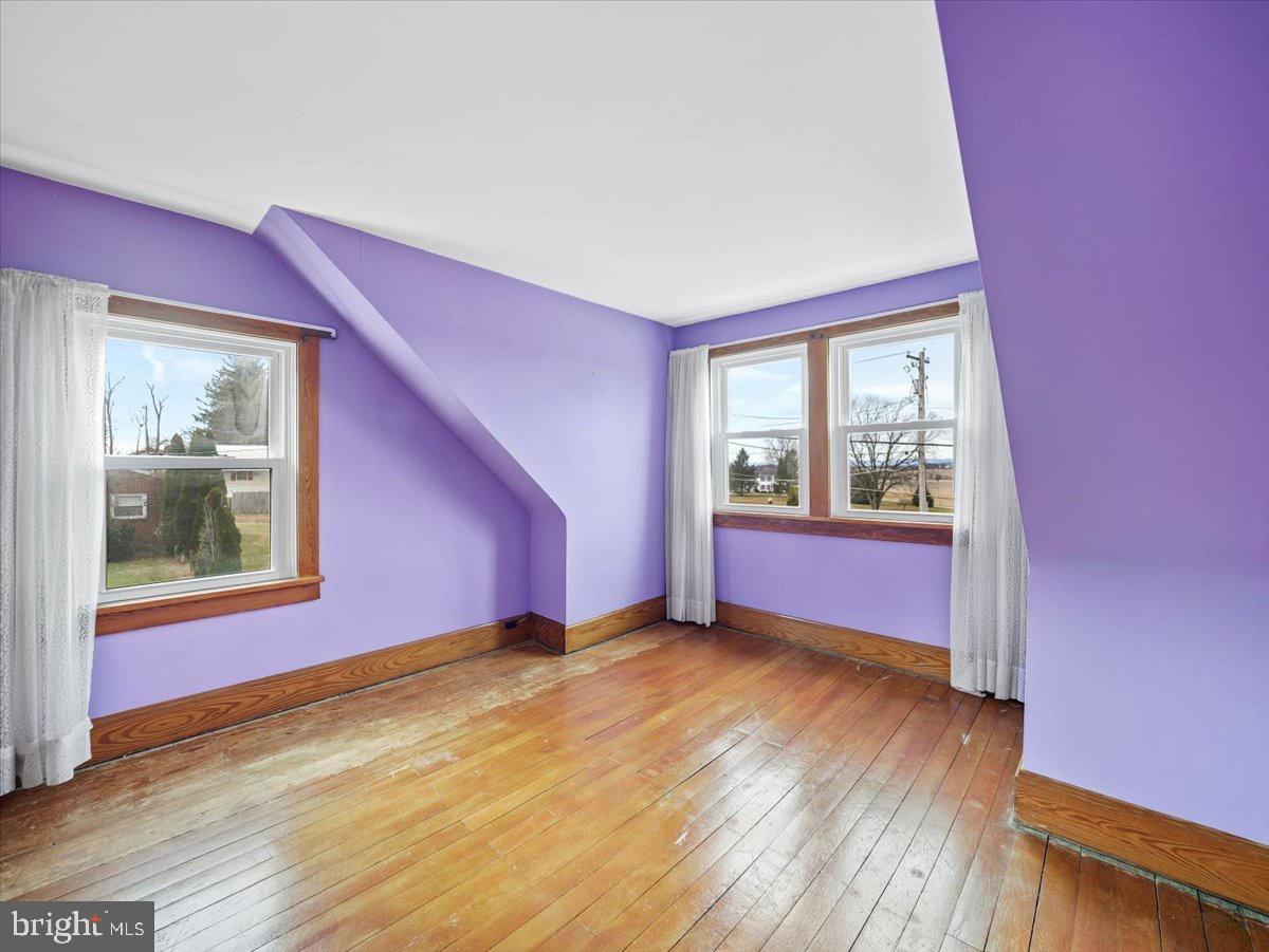 7220 Slabtown Road Waynesboro, PA 17268 - Photo 19 of 43 a view of an empty room with wooden floor and a window