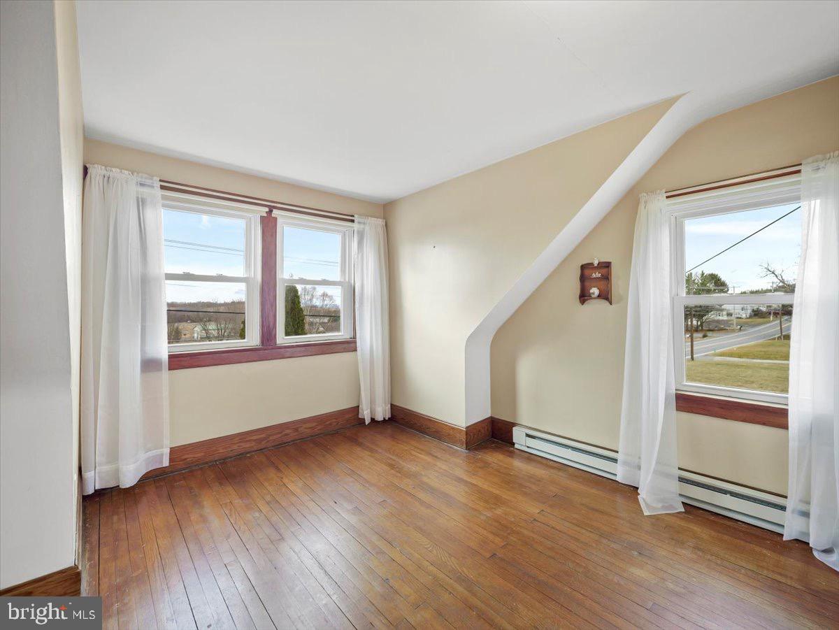 7220 Slabtown Road Waynesboro, PA 17268 - Photo 21 of 43 a view of an empty room with wooden floor and windows