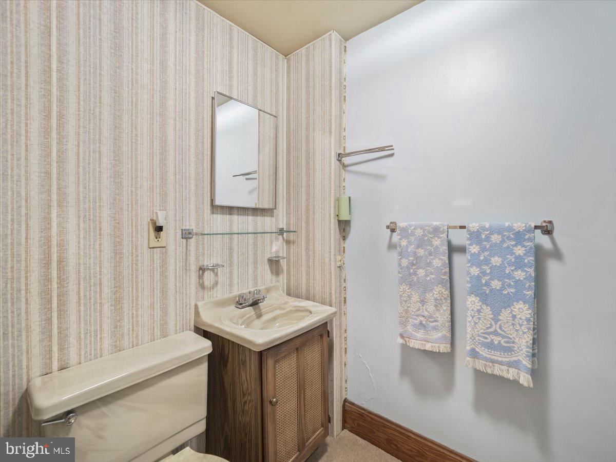 7220 Slabtown Road Waynesboro, PA 17268 - Photo 23 of 43 a bathroom with a sink and mirror with toilet
