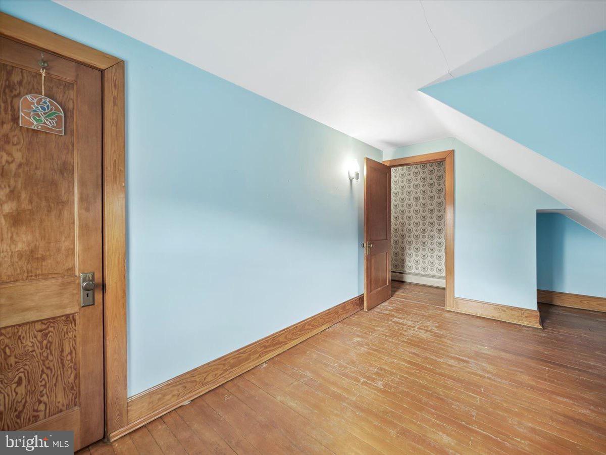 7220 Slabtown Road Waynesboro, PA 17268 - Photo 27 of 43 an empty room with wooden floor and entrance door